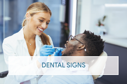 A dental technician helps a child prepare for imaging. The room is marked with a Metro room identification number and a Radiation In Use warning sign.