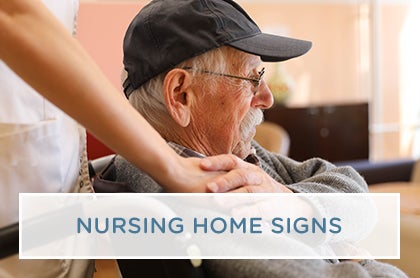 A skilled nursing professional provides attentive care to a senior resident in a nursing home.