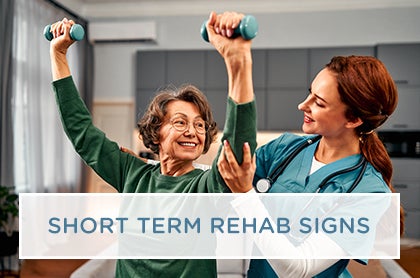 A physical therapist assists a senior resident with mobility exercises in a modern short-term rehabilitation center.