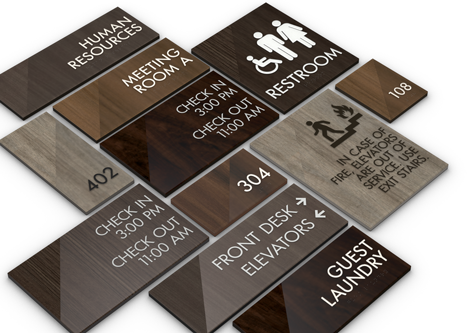 Assisted living signage mood board with restroom and room number signs, fabric swatches, and hardware