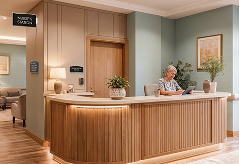 A resident walks through a modern senior care corridor with clear room identification and accessible wayfinding signs.
